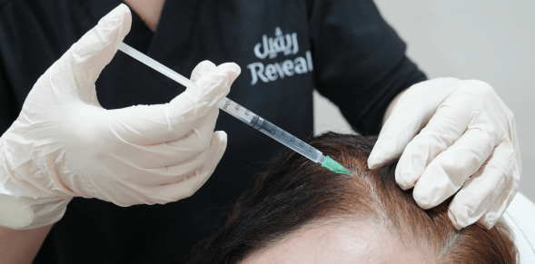 a woman getting hair treatments at reveal clinics in riyadh